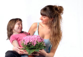 girl giving flowers to mom on Mother's day