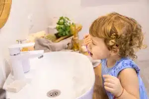 the child brushes his teeth in the bathroom 300