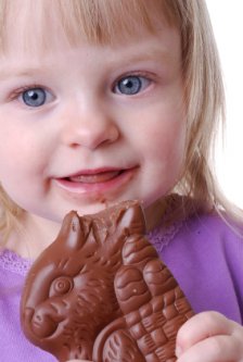 little girl eating a chocolate Easter bunny