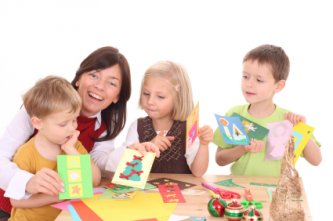 kids making Christmas cards with mom