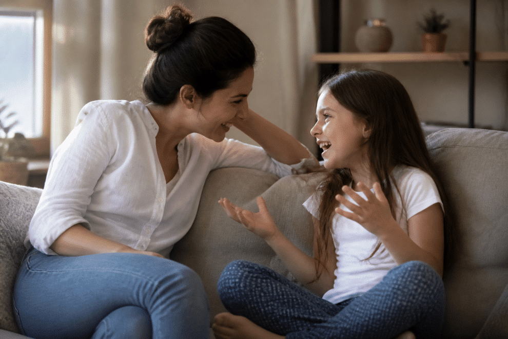 Being friends with your child — parent and child sharing a joyful conversation at home