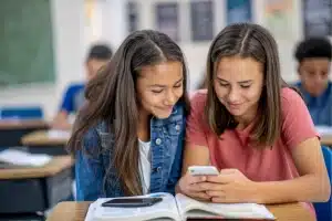 Effective Communication with Teens: Building Trust and Understanding in the Digital Age 8 teens on cell phone in school