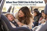 A warm mom of three leaning into the back seat of a car, calmly reassuring her crying toddler buckled into a car seat in soft daylight — a tender scene for parents whose child cries in car seat rides