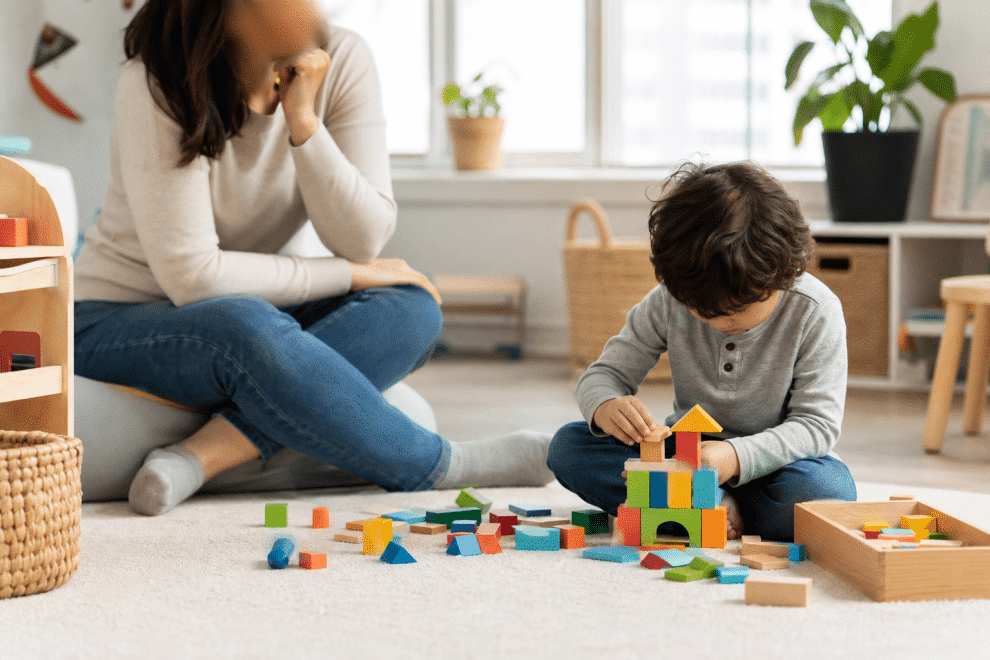 signs of ADHD in children — parent observing child's focused play and behavior