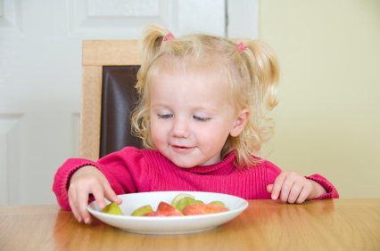 Snacks versus Treats: Encouraging Healthy Habits 9 toddler enjoying a healthy fruit snack