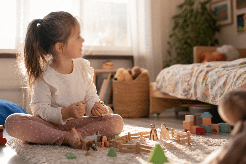 imaginary friends in children - young child playing imaginatively in a cozy bedroom