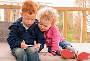Protecting Your Kids from Huggy Wuggy: The Terrifying Poppy Playtime Character 17 boy and girl on iphone
