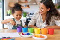 Fun Learning Activities for Preschoolers at Home: A Simple, Joyful Guide 1 Preschooler engaged in fun learning activities for preschoolers at home, sorting colorful everyday objects with a parent