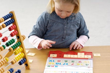 Fun Activities for Teaching Kids to Count 7 young girl playing a learning game