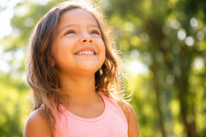 Optimistic kids smiling brightly outdoors
