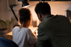 parenting a child with adhd - parent helping child focus on homework