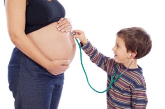 Pregnant mom and son checking her out