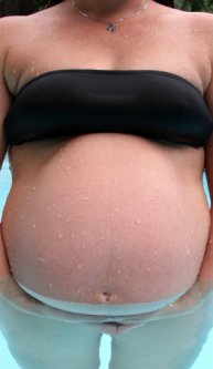 a pregnancy woman standing in a pool