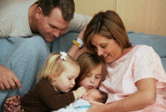sisters greet their newest sibling