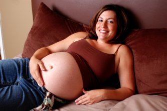 Pregnancy Pillow - A Wise Investment? 8 pregnant woman resting comfortably in bed