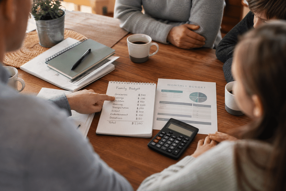 family budget tips - family reviewing household budget at kitchen table