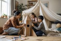 The Surprising Importance of Play: Why Free Time Is So Good for Kids 1 The importance of play in action — children building a blanket fort in a bright family room while a parent sits nearby.