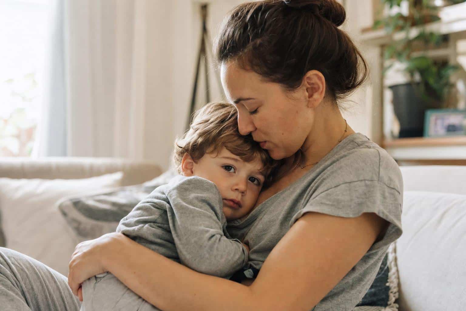 How to Handle Toddler Tantrums: Calm, Gentle Steps for Every Family 8 A parent and toddler quietly reconnecting after an upset moment — parent holding the child gently, both calm, warm light in a home setting.